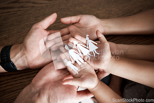 Image of Hands, paper cutout family and house on table for sign, symbol or icon of support, love and solidarity. Art design with mother, father and children together for safety, trust and insurance in home