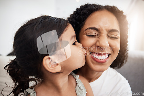 Image of Kiss, love and girl with mother on a sofa, happy and smile while bonding in their home together. Family, kisses and parent with child on a couch, bond and cheerful, loving and caring in a living room