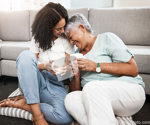 Image of Relax, laughing and senior mother and daughter with coffee cup for home conversation, talking and bonding together. Black family, people or woman with elderly mom love, tea and living room carpet