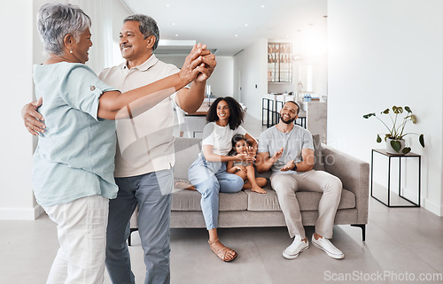 Image of Senior couple, dancing and happy family with love, support and care together in home living room. Men, women and child or parents and grandparents in young for happy quality time and bonding in house