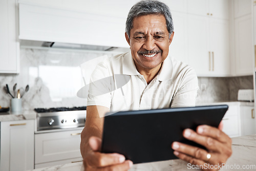 Image of Mature man, tablet and home on social media, internet and reading online news application. Happy grandpa, digital technology and connection in house for networking, website search and ebook for smile