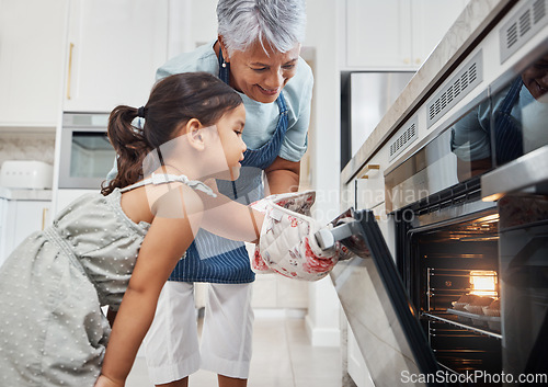 Image of Cooking, learning and grandmother with girl by oven in kitchen baking delicious muffins. Education, development and happy grandma teaching kid how to bake, bonding and enjoying quality time together.