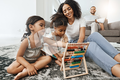 Image of Mother, children and floor with abacus for math learning, teaching or sibling teamwork in family home. Kids, carpet and education toys with mom, dad and sofa with smile, pride and happiness in house