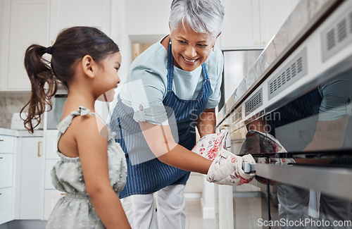 Image of Learning, cooking and grandmother with girl by oven in kitchen baking delicious meal. Education, development and happy grandma teaching kid how to bake, bonding and enjoying quality time together.