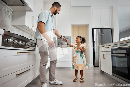 Image of Family, father and girl dance in kitchen together for bonding, quality time and affection at home. Family, love and happy dad with girl dancing, smile and holding hands for fun, relaxing and carefree