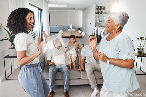 Image of Happy family, mother and daughter dancing with love, support and care together in home living room. Women, men and child or parents and grandparents in lounge for happy quality time and bonding