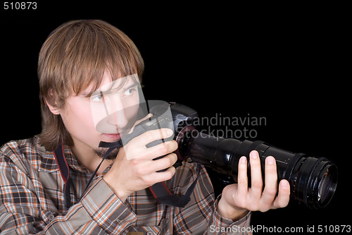 Image of Young  photographer with the camera with a zoom lens