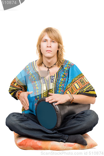 Image of The young man plays a drum. Isolated 