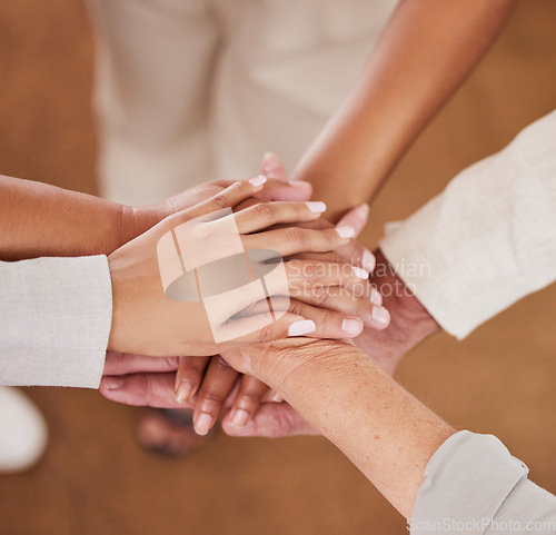 Image of People, hands together and unity above in trust for community, agreement or teamwork at the office. Group piling hand for team collaboration, support or coordination for corporate goals in solidarity