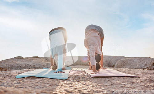 Image of Yoga, exercise and woman friends on the beach together for mental health, wellness or balance in summer. Exercise, diversity or nature with a female yogi and friend outside for health or mindfulness