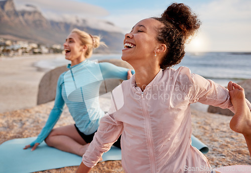 Image of Yoga, laugh and woman friends on the beach together for mental health, wellness or fun in summer. Exercise, diversity or nature with a female yogi and friend laughing or joking outside for humor