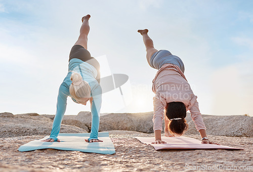 Image of Yoga, stretching and fitness with friends on the beach together for mental health or wellness in summer. Exercise, diversity or nature with a woman yogi and friend outside for inner peace or balance