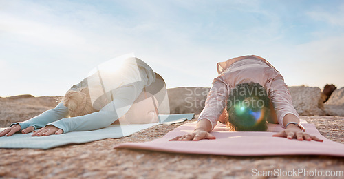 Image of Yoga, women or child pose on rock mat in workout, training or bonding exercise for back pain. Relax, stretching or yogi friends in beach, nature pilates or fitness flexibility for healthcare wellness