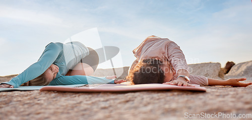 Image of Yoga, women or stretching on beach mat in workout, training or bonding exercise twist for back pain. Child pose, relax or yogi friends in nature pilates or fitness flexibility for healthcare wellness