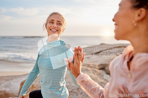 Image of Fitness, touching hands and couple of friends at the beach for workout, training or exercise together for support. High five with love of diversity woman or lesbian people for cardio care by ocean
