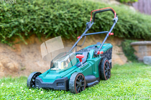 Image of battery electric lawn mowers in the garden