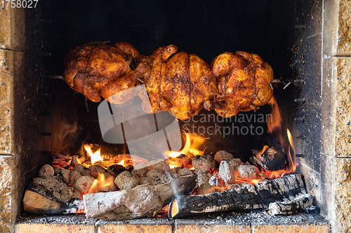 Image of chicken roasting on a spit