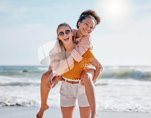 Image of Piggyback, beach and couple of friends in portrait for lgbtq, lesbian or gay love, freedom on summer vacation. Blue sky, ocean and diversity women on date, fun support and excited valentines holiday