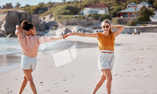 Image of Couple holding hands on beach, lesbian and fun by ocean, gay women outdoor with adventure and freedom to love. Interracial, laugh and holiday in Australia, lgbtq with travel and happy dance together