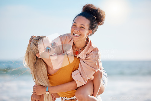 Image of Women, friends and piggy back on beach, vacation and on weekend break with happiness, loving and bonding together. Female carry lady, girls and adventure on summer holiday, getaway or playful outdoor