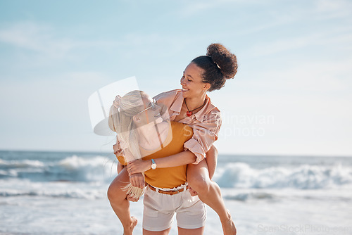 Image of Piggyback, ocean and happy couple of friends for lgbtq, lesbian or love and freedom on summer vacation together. Blue sky, beach and diversity women on date, fun support or excited valentines holiday