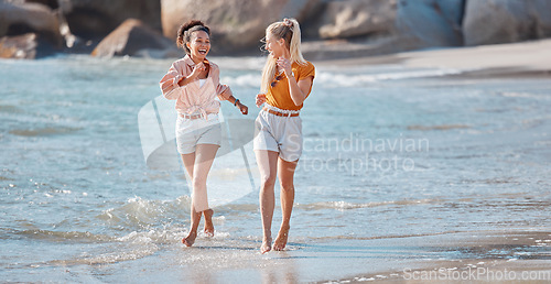 Image of Couple on beach, lesbian and happy in ocean, gay women outdoor with adventure and freedom to love. Interracial relationship, laughter and holiday in Australia, lgbtq with travel and running in water