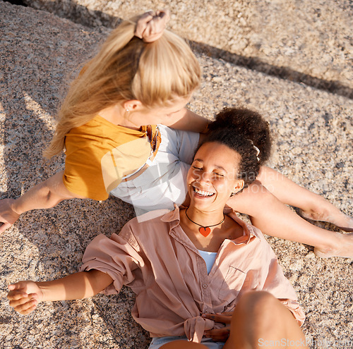 Image of Above, friends and relax at the beach for summer, vacation and bonding while lying on the ground together, happy and laugh. Smile, travel and women on floor with peace, freedom and chilling outdoors