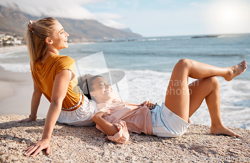 Image of Beach, relax and women at the sea for travel, sightseeing or fun on vacation against blue sky background. Happy, friends and ladies smile, talk and bond at ocean with peace, freedom and joy in Miami