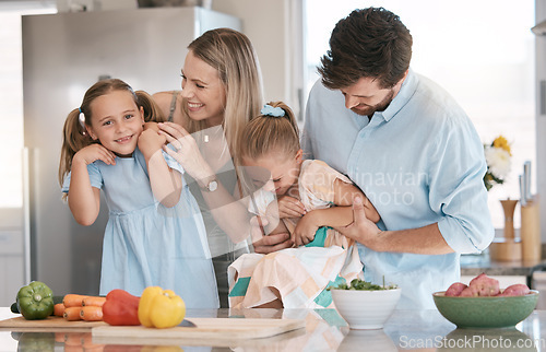 Image of Portrait, playful and family cooking food, bonding and children helping in the kitchen for lunch. Happy, laughing and parents playing with girl kids while preparing dinner together for quality time