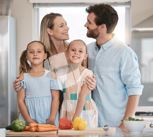 Image of Parents, food and portrait of children cooking with vegetables for lunch, dinner or ingredients for meal prep. Family, smile and mom, dad and girls learning, teaching and helping at kitchen table