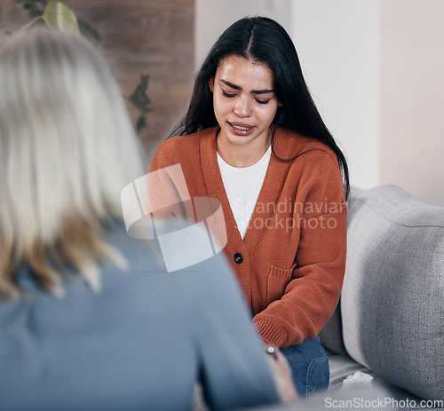 Image of Sad woman, therapist and crying in consultation for addiction, mental health or support counseling. Female patient and counselor or shrink helping solve issue in healthcare, therapy session or advice