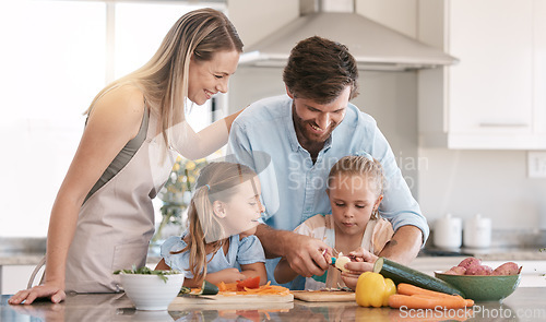 Image of Kitchen, family and parents with children cooking with vegetables for nutrition, healthy food or meal prep. Chef skills, home and mom, dad and girls learning, teaching and helping peel ingredients