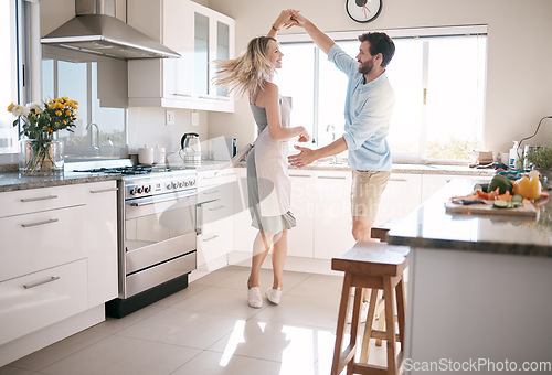 Image of Couple, bonding or dancing in kitchen, house or family home in support, love or trust in fun activity, energy freedom or celebration. Smile, happy or dancer man and woman in romance marriage ballroom