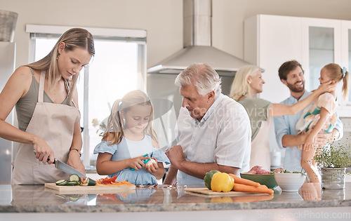Image of Big family, cooking and vegetables with a child helping mother and grandfather in the kitchen. Woman, man and girl kid learning to make lunch or dinner with love, care and bonding over food together