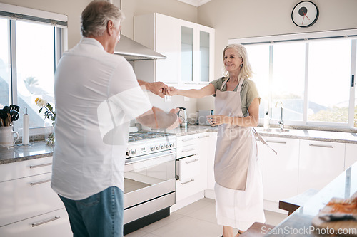 Image of Senior couple, bonding and dancing in kitchen, house or family home in support trust, love or fun energy celebration. Smile, happy and retirement man in dance with elderly woman in romance marriage