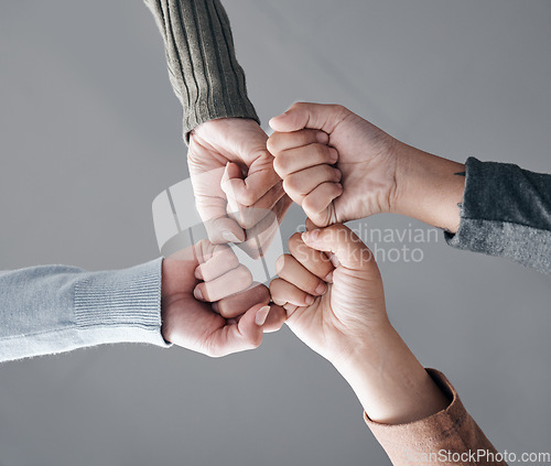 Image of People, hands and fist bump in trust for unity, collaboration or team agreement in solidarity. Hand of support group bumping fists in teamwork, partnership or coordination for community achievement