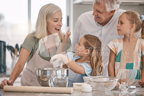 Image of Family, playful or baking children with flour wheat in kitchen, house or home of pastry cookies, dessert cake or food. Happy, grandparents or cooking kids playing, bonding or learning bakery pudding