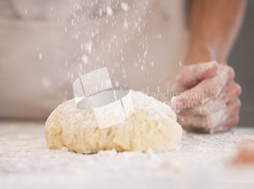 Image of Woman hands, baking or flour sprinkle on kitchen table, countertop or desk for pastry dish, wheat cake or lunch pie food. Zoom, chef or cooking dough for bakery pudding, dessert or cookies in house