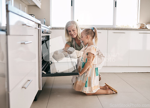 Image of Kitchen, grandmother and child baking bread together in oven in their modern family home. Happy, smile and girl kid helping senior woman grandma in retirement bake for dinner, party or event at house