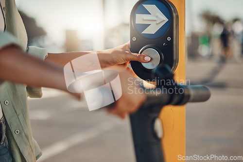 Image of Woman, hands and pressing pedestrian crossing signal for safety, security or assurance for travel in the city. Hand of female at traffic light pushing button for crosswalk or street on electric bike