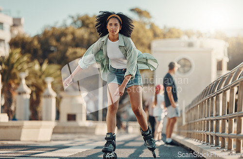 Image of City, exercise and black woman roller skating for fitness, health and wellness outdoors. Sports practice, training and portrait of young female skater exercising, recreation or workout in street.