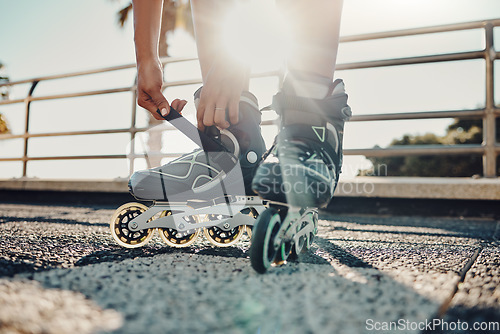 Image of Fitness, hands and tie roller skates in city to start workout, health and wellness exercise. Sports practice, training and black woman skater tying shoes in street to get ready for skating outdoors.