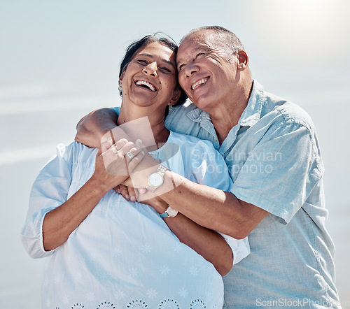 Image of Retirement couple, laughing and hug at beach for love, care and relax on summer holiday, trust or date. Happy senior man, woman and embrace at sea for happiness, support and smile in outdoor sunshine