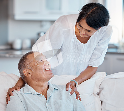 Image of Love, retirement and relax with a senior couple in the living room of their home together for bonding. Sofa, happy smile or marriage with a mature man and woman relaxing in the lounge of their house