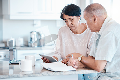 Image of Senior couple debt, tablet and home of elderly people in retirement looking at budget data. Pension, house research and finance loan of a Indian woman and man together in a kitchen planning with tech