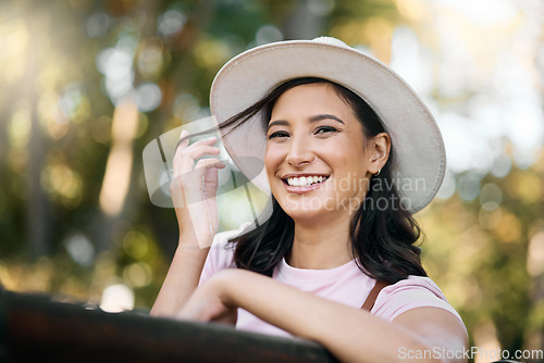 Image of Woman, park and portrait of a female traveler on a garden bench with a smile from travel. Freedom, happiness and hair twirl of a Asian person on holiday feeling happy on vacation enjoying nature