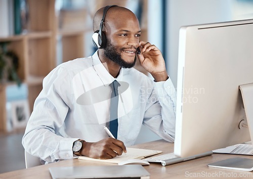 Image of Call center, customer service and man consultant writing notes while doing a consultation online. Contact us, operator and African male telemarketing agent on computer planning crm strategy in office