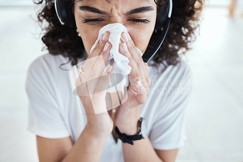 Image of Call center, customer support and woman blowing her nose with tissue for a cold, flu or covid. Sick, illness and female telemarketing consultant sneeze with allergies, hayfever or sinus in the office