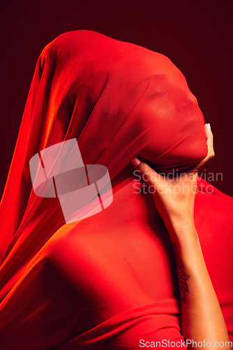 Image of Model, red fabric and hide face for fashion, aesthetic and beauty with dark studio background. Gen z woman, cloth or silk veil for creativity, vision and art with retro, vintage or creative clothes