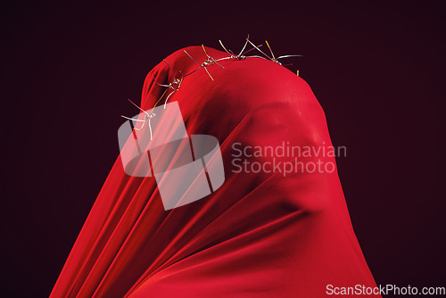 Image of Red fabric, creative aesthetic and model in a studio with face covering for religion and luxury clothing. Glamour, religious thorn crown and woman with god respect wearing vintage and silk apparel